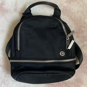 Never used lululemon black mini backpack with silver zippers & logo